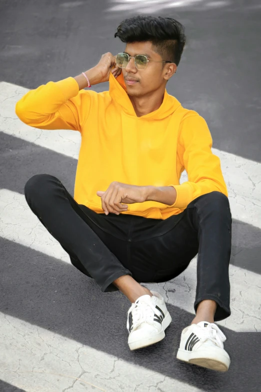 a person in a yellow shirt sitting on the ground