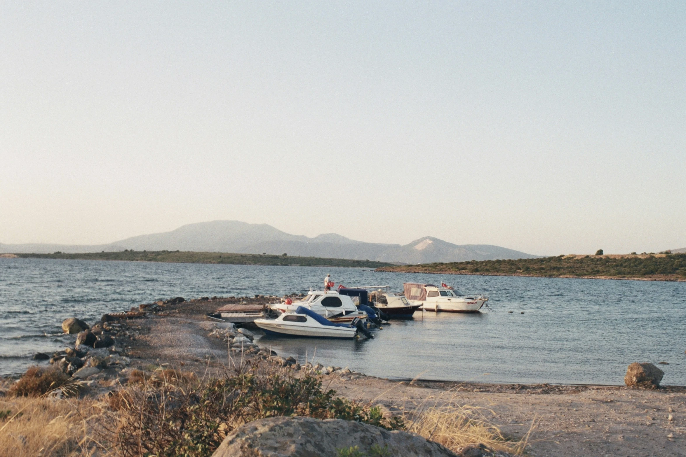 a marina with four boats tied to one end