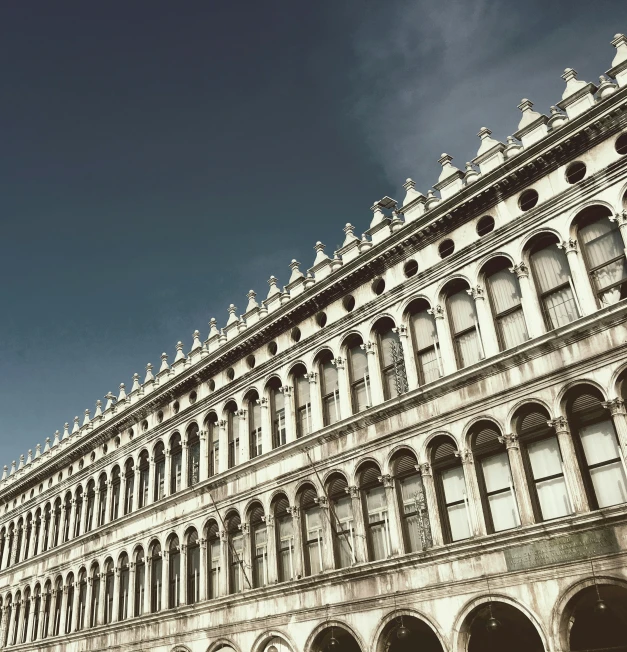 old buildings and statues line the sides of a large street