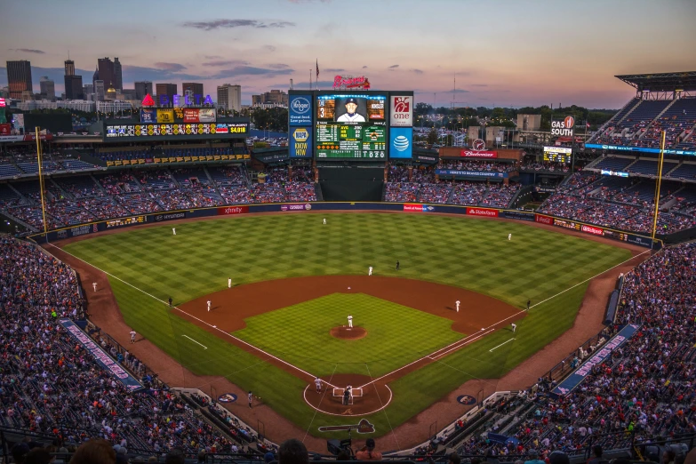 a stadium full of people in it with the light on