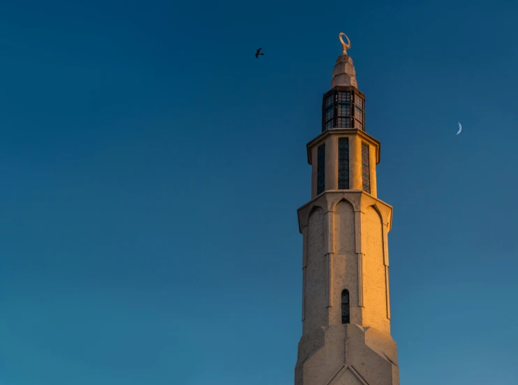 the tall tower of the building has a clock on it