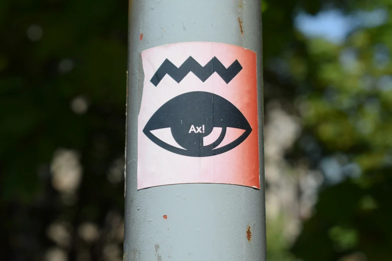 a sticker on a light pole with a design on the stick