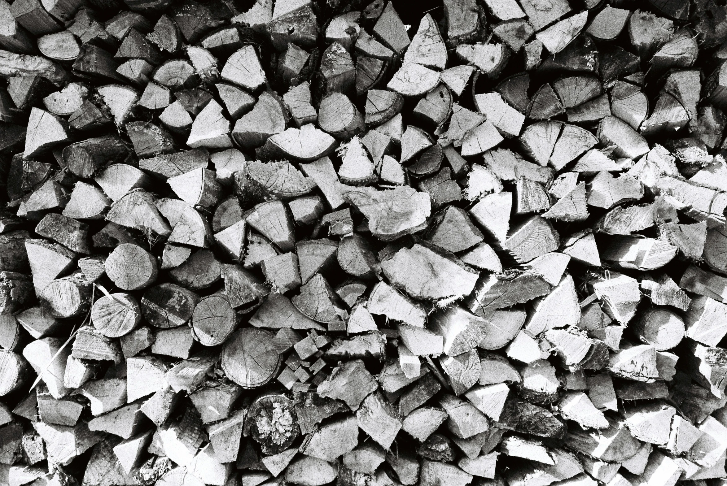 black and white pograph of wood chips stacked together