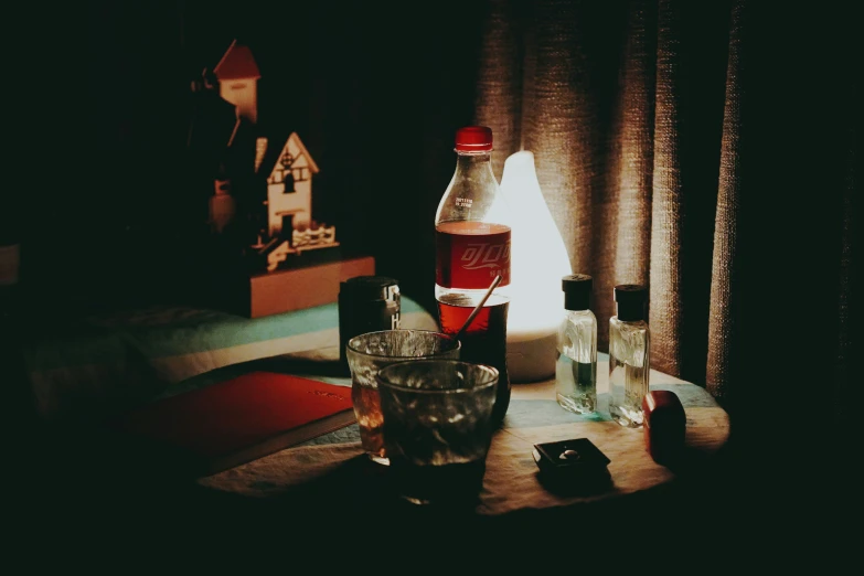 a bottle of alcohol sits on a table with some glasses