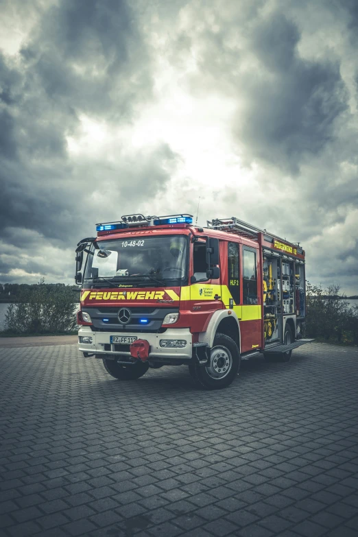 a large red fire truck parked in the gravel