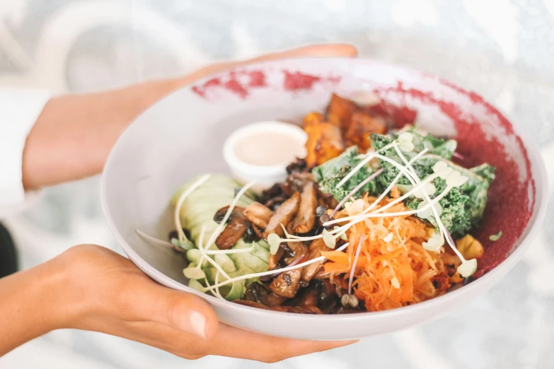 a plate full of food on a person's arm