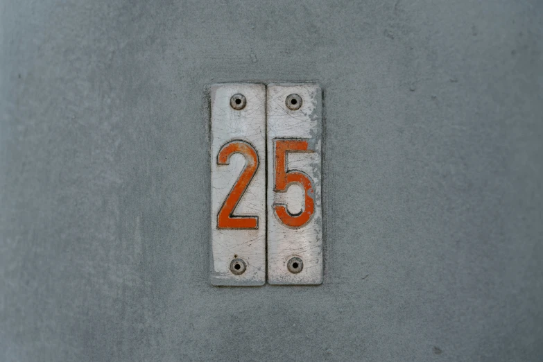 two numbers are on the grey wall and white is below