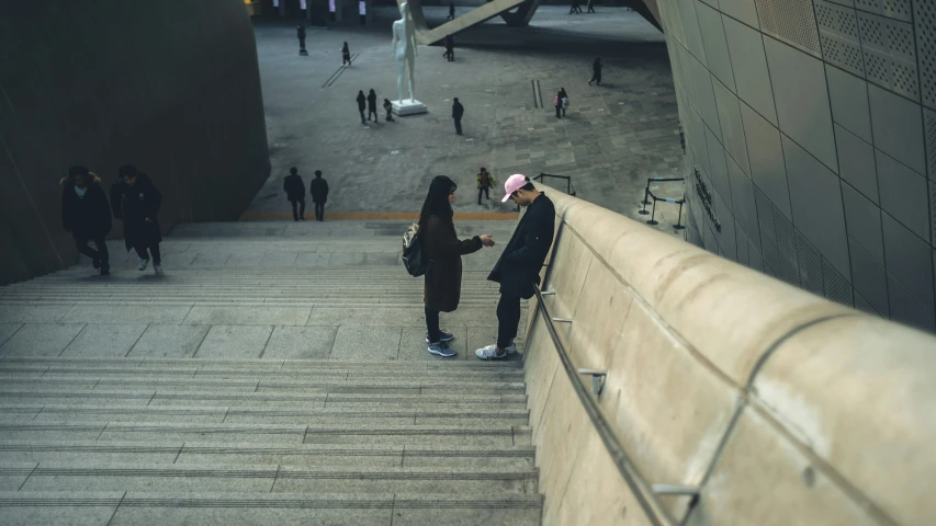 two people are walking up a set of steps