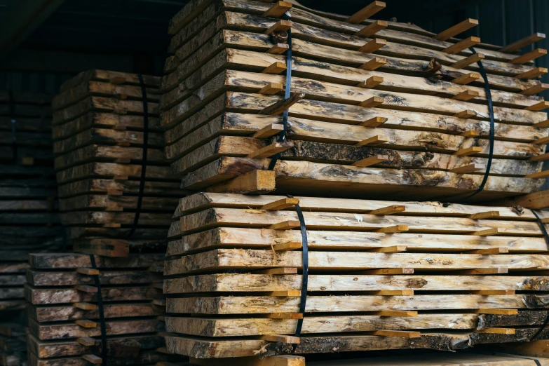 a large pile of wooden planks stacked together