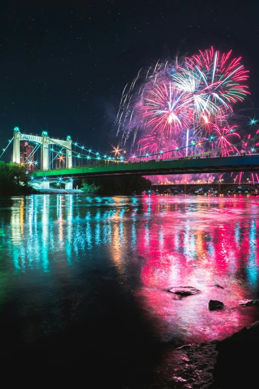 a fireworks show at the end of a long bridge