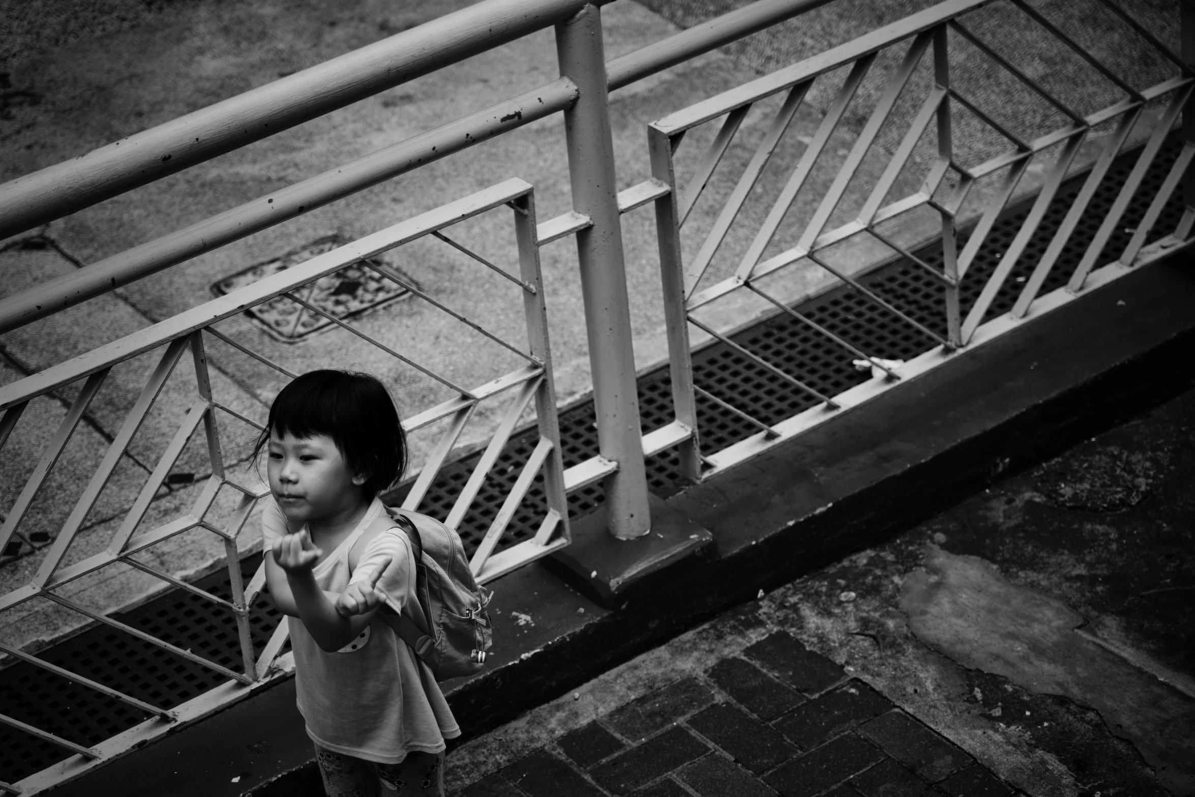 a young asian girl walks up a set of steps