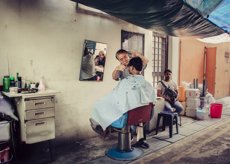 the woman is sitting in her chair at the hair salon