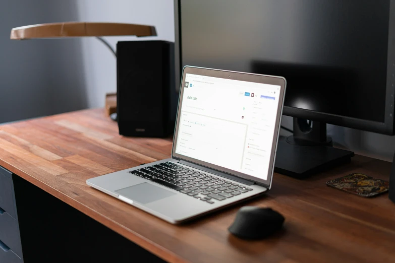 a laptop that is on a wooden desk