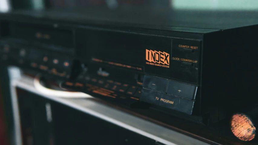 the radio is black with orange lettering on the front