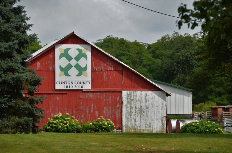 a barn with an old logo on the front