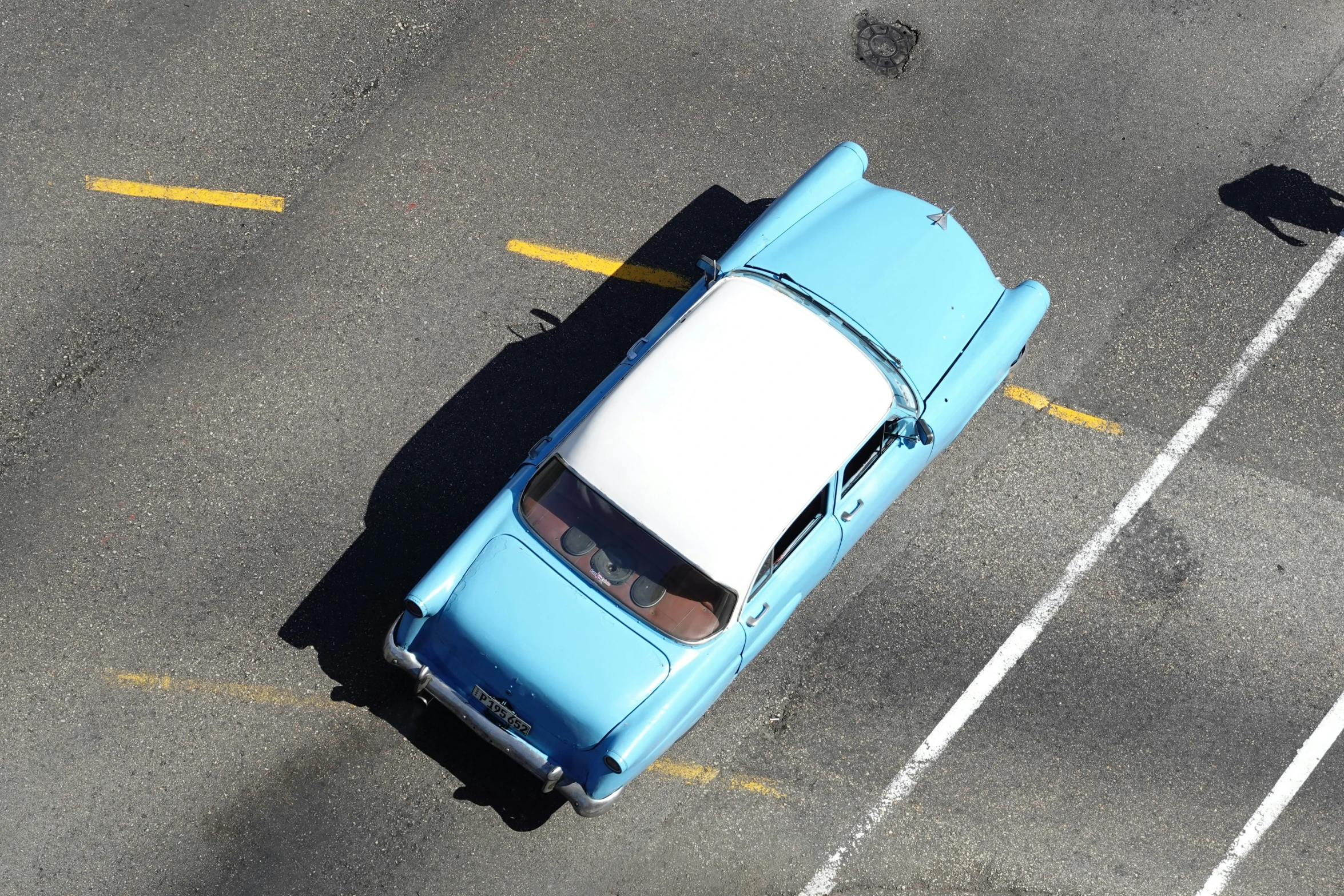 an overhead view of a car parked in a lot