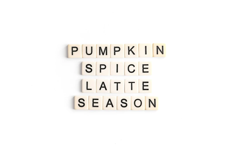 the words pumpkin spice late season spelled on wooden scrabble