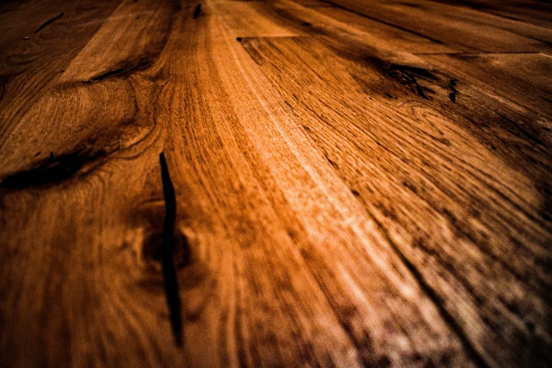 a wood table that has some black and brown stain