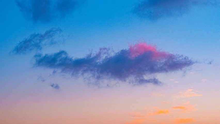 a airplane flying by the sunset as it looks like its going to land