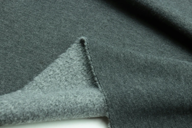 a gray coat with a triangle design on the side