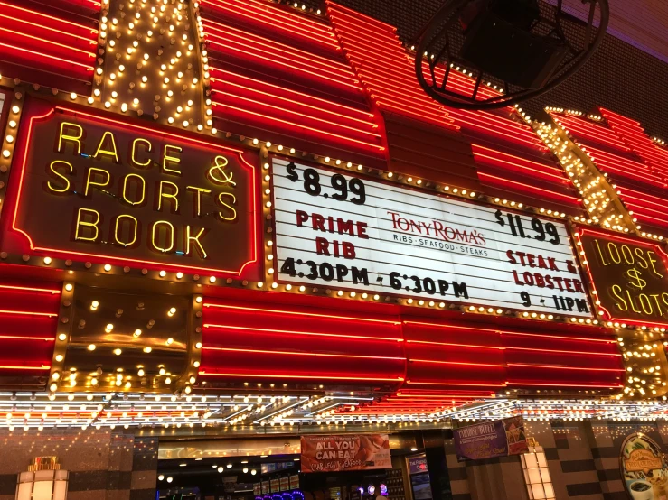 the race and sports book sign lit up in the night