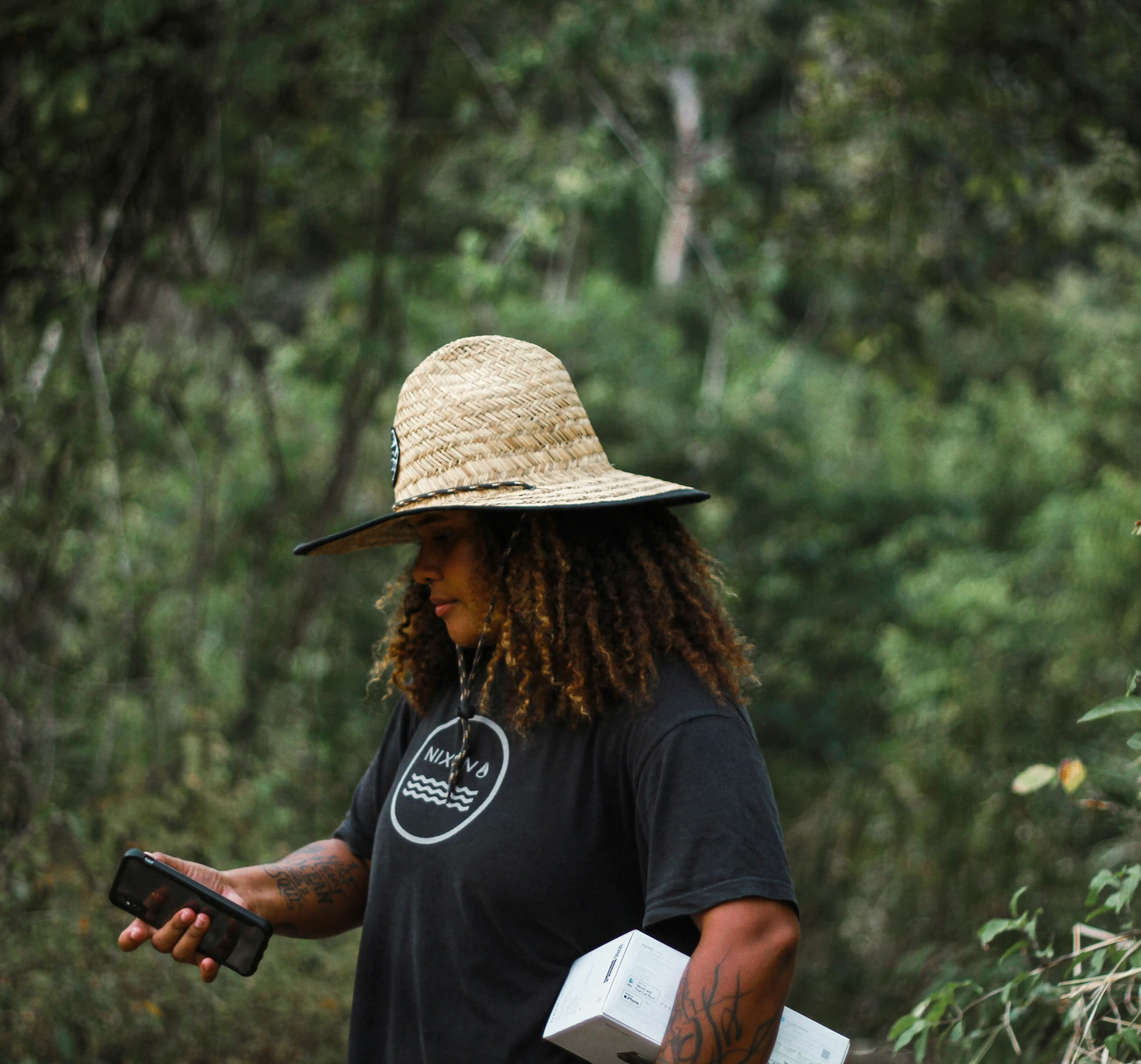 the man is carrying his phone in a hat