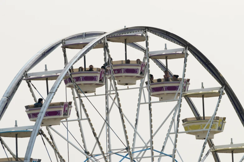 a ferris wheel with seats full of people