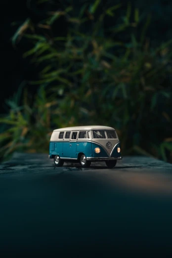 a small toy bus sits in front of plants