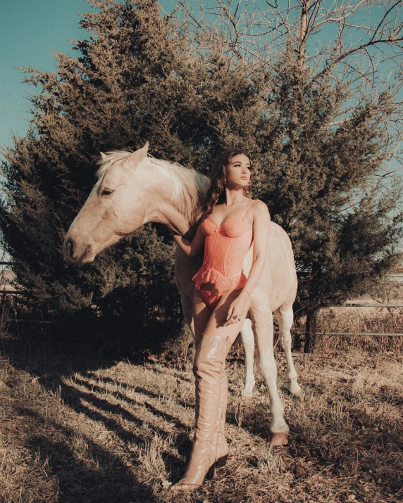 a person standing in front of a horse next to some trees