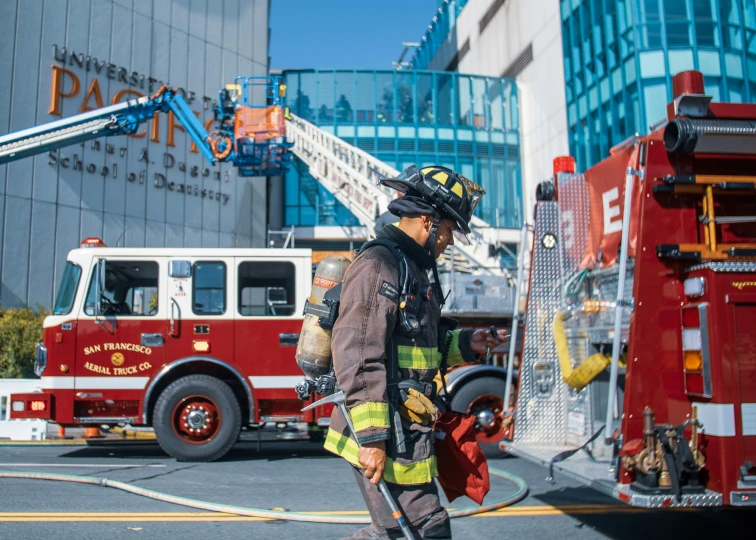 a firefighter stands in front of a fire truck