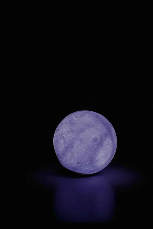 a blue moon glows in the dark night sky