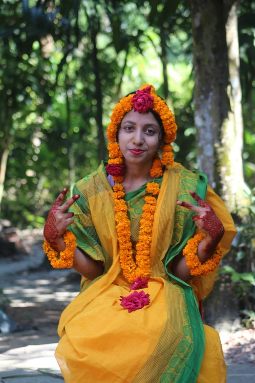 a woman dressed in yellow and green doing a gesture