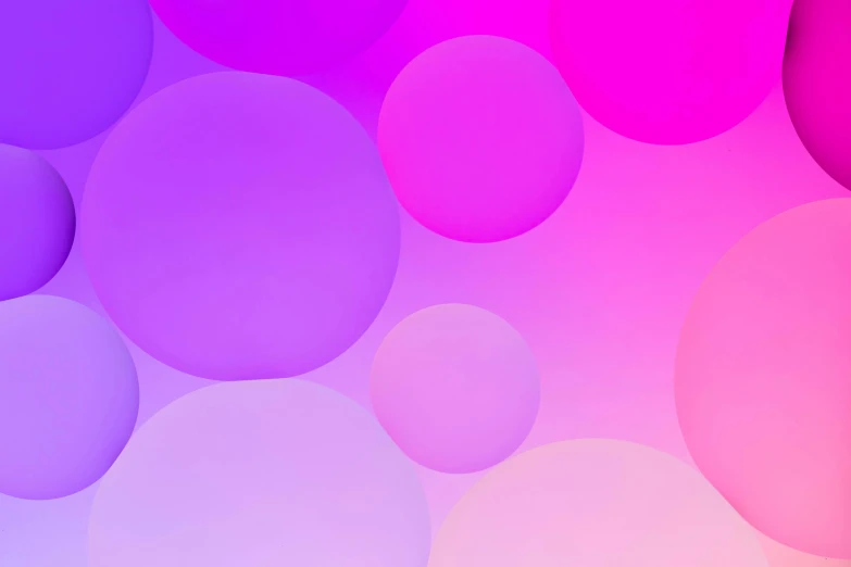 many different colored circles on a light purple background