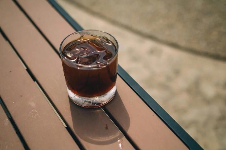 a soda sitting on top of a wooden table