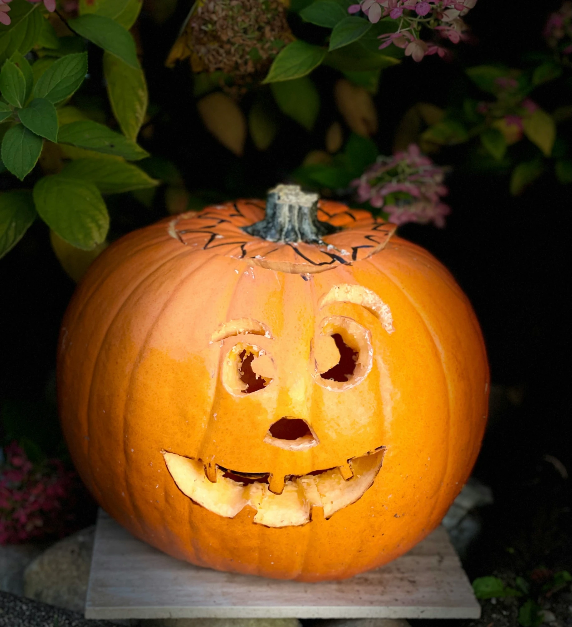 a small pumpkin has been carved to look like a smile