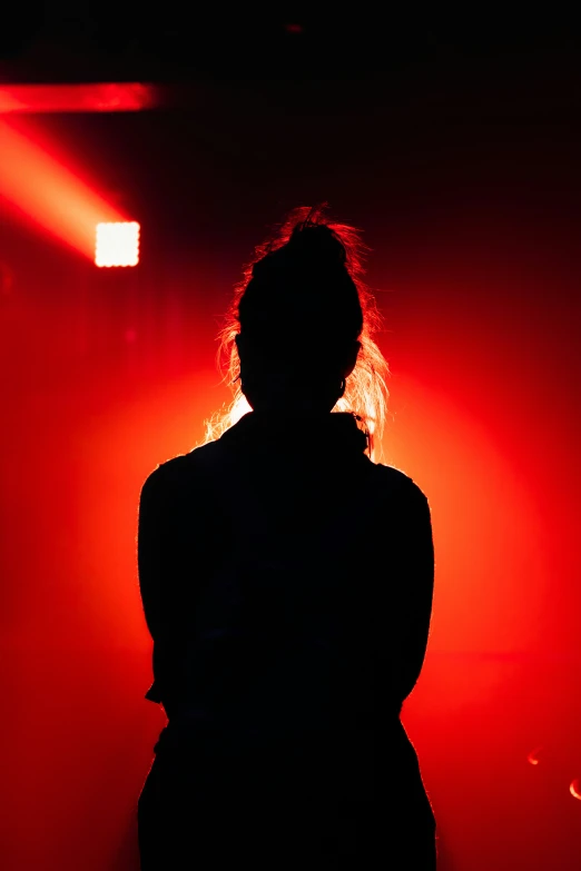 a person in the shadow of a stage light