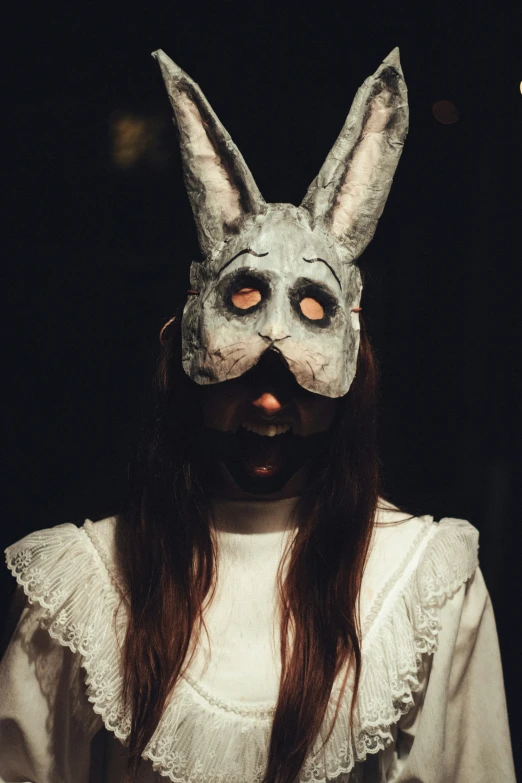 a person wearing a bunny mask and white blouse