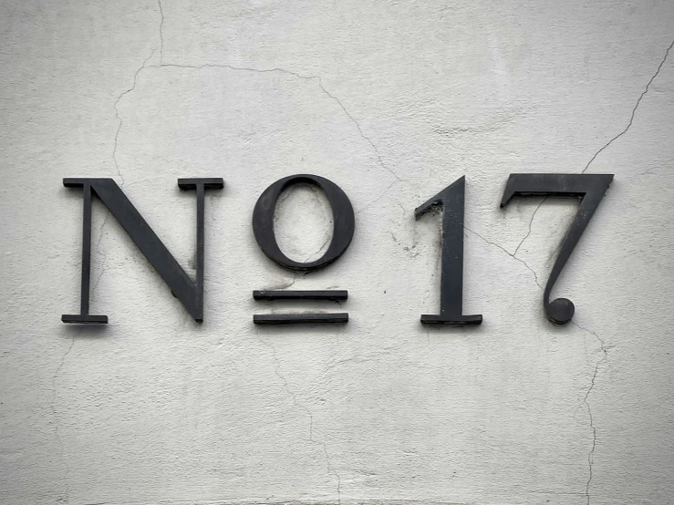 the number nine seven written in black on white cement