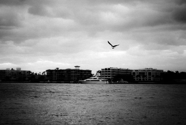 an airplane flies in the sky over a large body of water