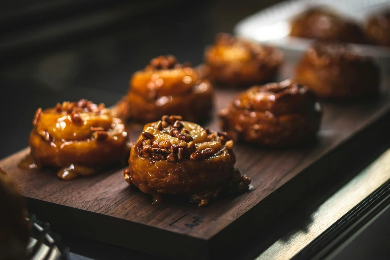 several donuts are sitting on a  board