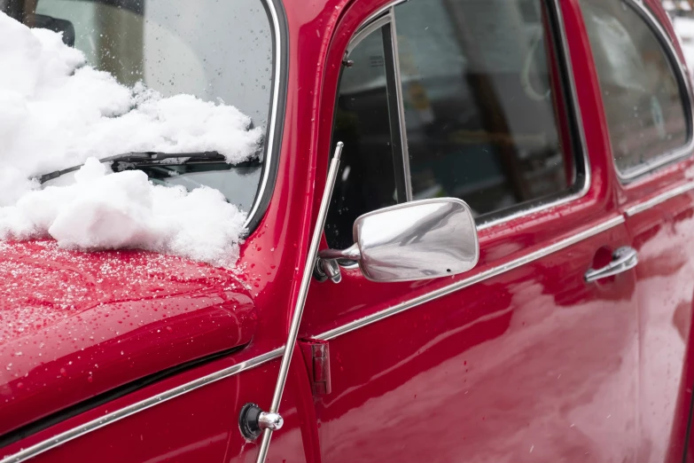 there are some cars covered in snow that are parked on the side of the street