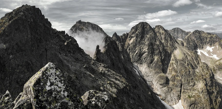 the mountains have clouds coming up from them