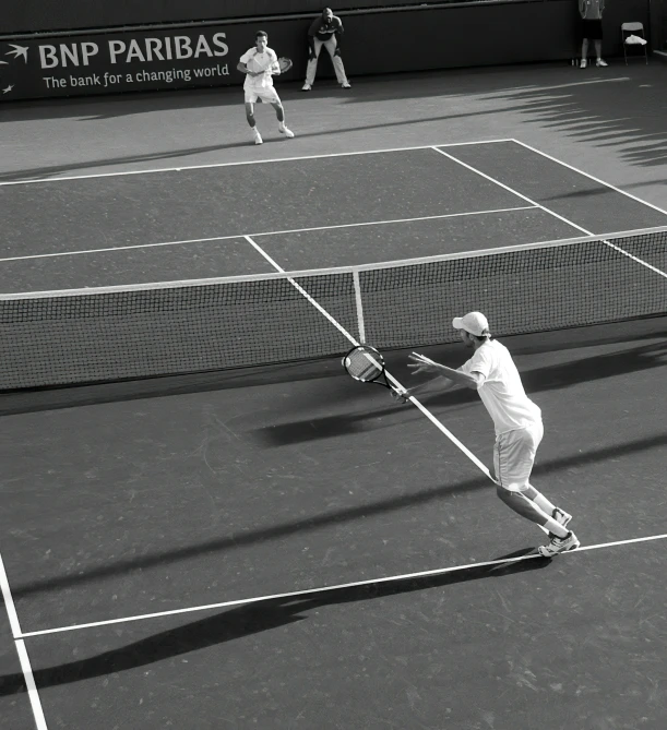 a tennis player is holding his racket back to hit the ball