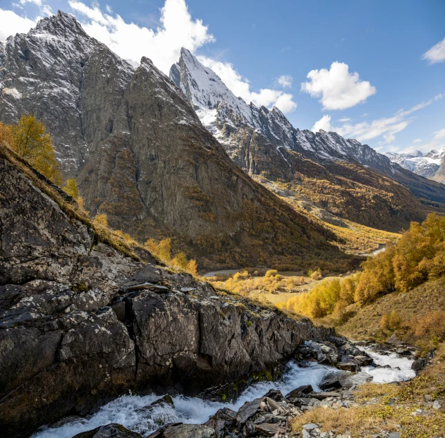 a mountain with some rocks and a river