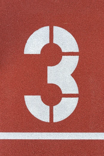 a red and white number three sign with white lines