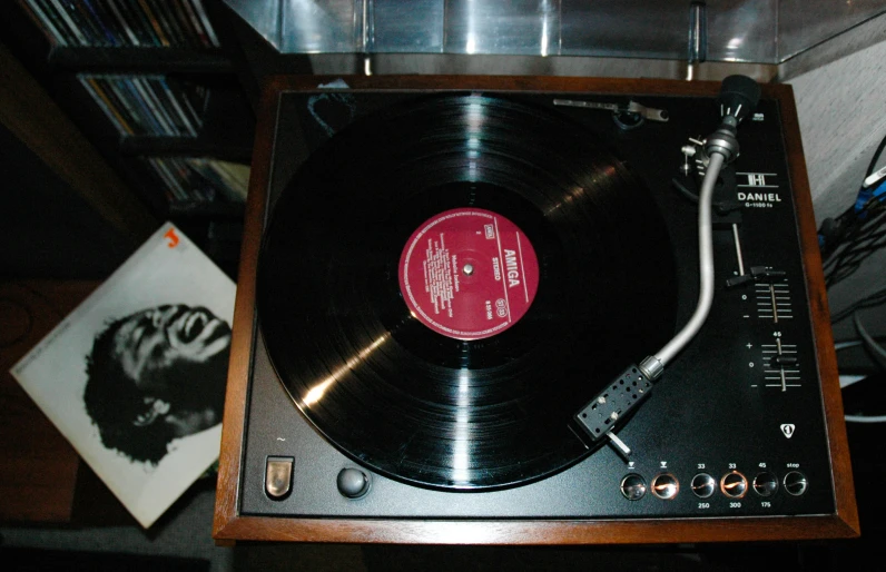 an old fashioned turntable with vinyl and tape