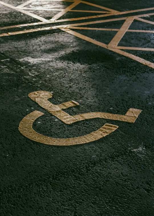 an ironed disabled parking sign on a wet pavement