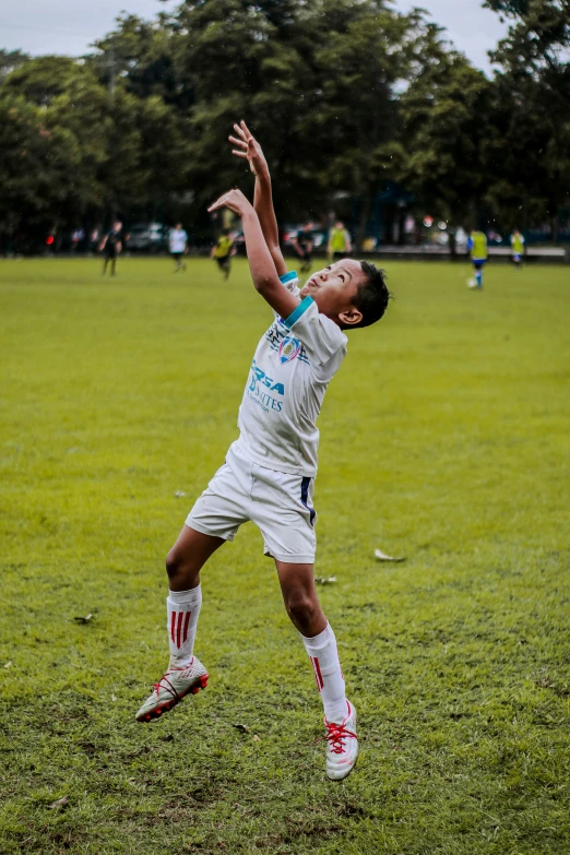 a young man jumping up in the air to catch a flying frisbee