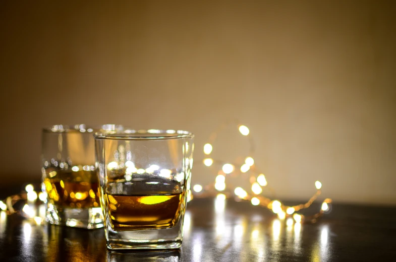 three glasses of whiskey sitting next to each other on a table