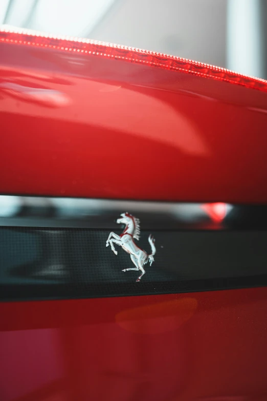 ferrari emblem is seen on a red car